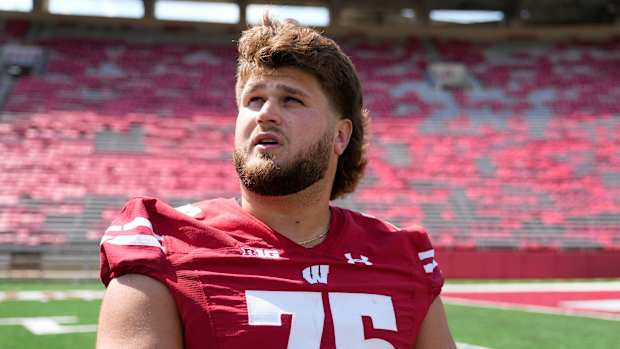 Wisconsin offensive lineman Joe Tippmann speaking with reporters during media day.